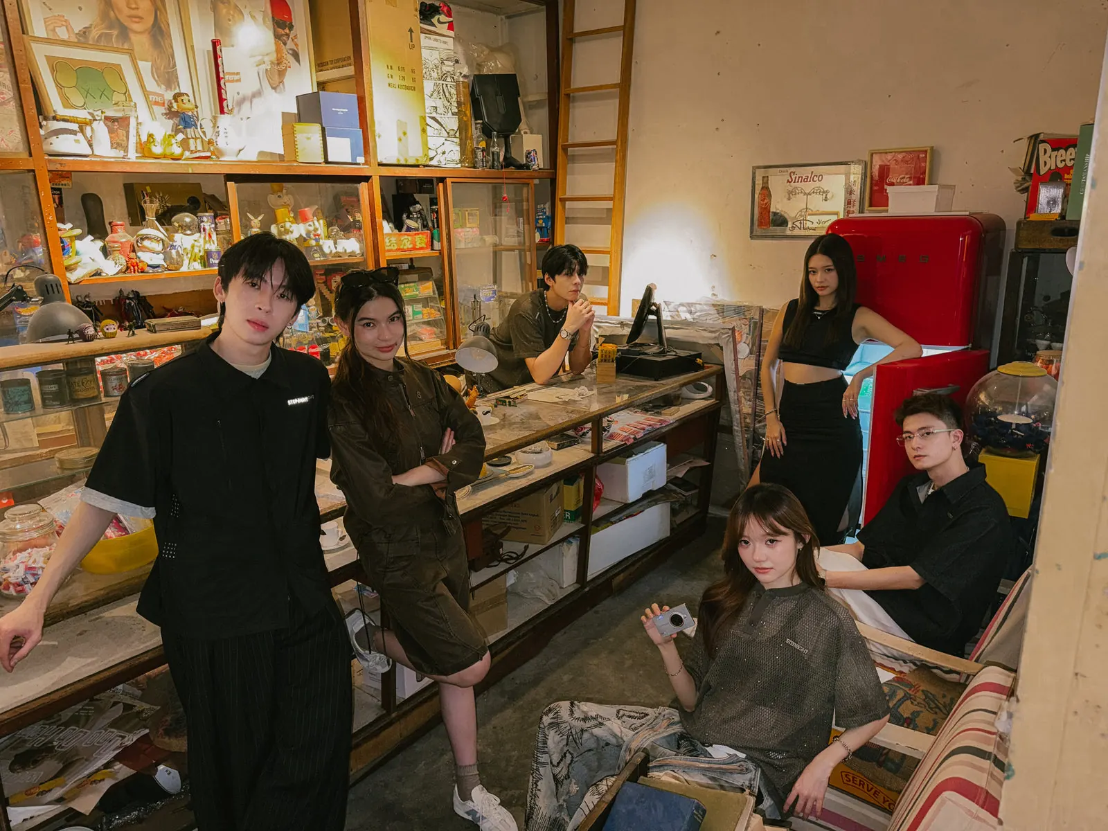 The STEP8IGHT crew in a cluttered vintage shop